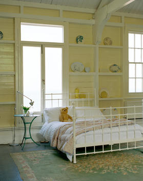 double iron bed in yellow room