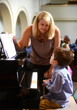 Mother from family who loves music gives her cute son, age 4-6, a pep talk before he performs in his first piano recital