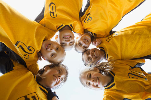 Portrait of soccer players forming huddle