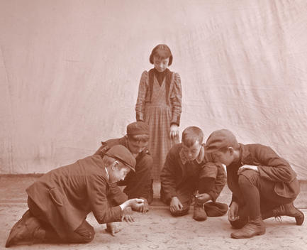 A Group Of Boys Posed In A Studio With A Girl On Looking, Playing Dice.