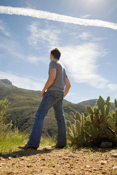 Young Man Stands Next To A Cactus In The Rancho Sierra Vista Region Of The Santa Monica Mountains In California.