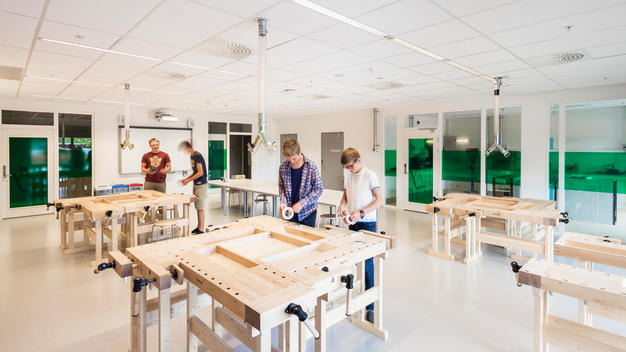 Student\'s in the woodwork classroom at Bjoernsletta School, designed by L2 Arkitekter, Oslo, Norway.