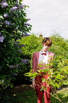 Woman Wearing Red Striped Outfit In A Garden