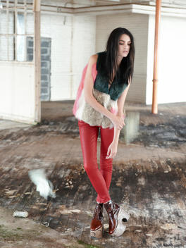 Fashion Model In Red In Dilapidated Room