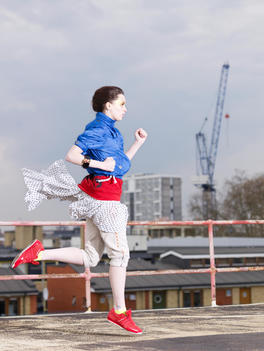 Fashion Story Based On A Theme Of Urban Street Wear, Photographed On An East London Rooftop, Female Model Jumping Wearing A Colorful Outfit
