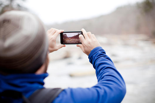 Man takes photo with phone of scenic space
