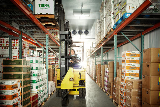 Forklift And Driver In A Cold Storage Facility