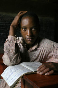 Emmanwel Kamari, born 1987. Young student with his text book at a school in Rwanda, East Africa. African children studying. African school. 10th anniversary of the Rwandan Genocide, April 2004. Part of their education includes \'civil liberties\' classes wh
