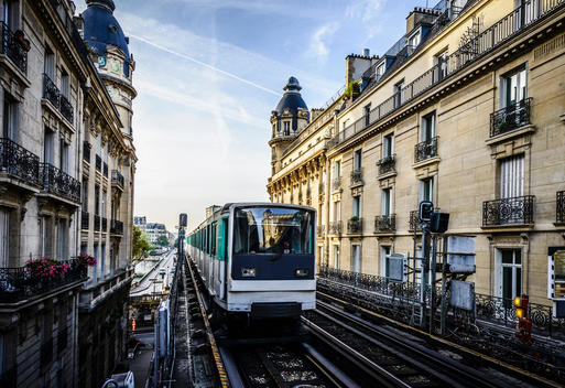 Streetcar passing between apartment buildings, Paris, France