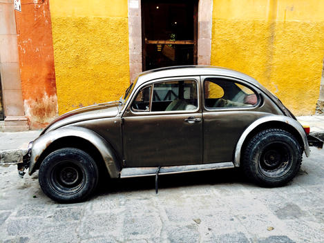 A old fashioned black Volkswagen bug on the streets in Mexico.