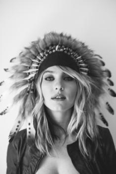 Black and White portrait of a blonde girl in an Indian head dress.