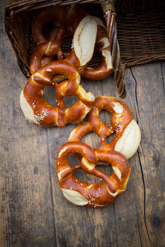 Basket of salted pretzels on wooden table