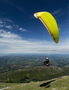 A pilot flying a paraglider at the second edition X-Pyr paraglading and hiking competition in Larun, Spain.