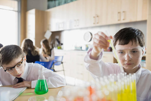 School boys conducting experiment in science classroom