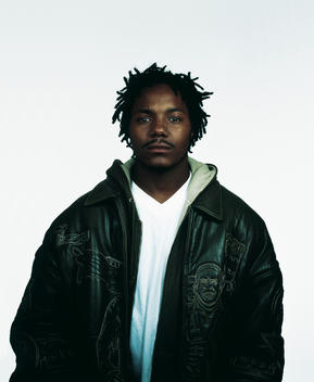Portrait Of Man With Dreadlocks Against White Background