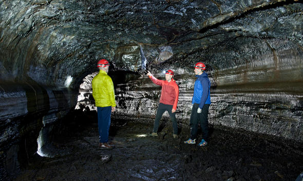 People in Leidarendi cave lava tube, Tvibollahraun lavafield, Hafnarfjordur, Reykjavik, Iceland