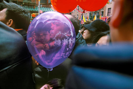 Boy Holding Balloon in Chinatown Parade.