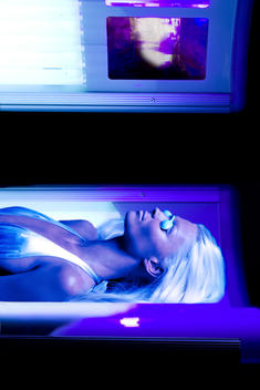 Young female in a tanning bed
