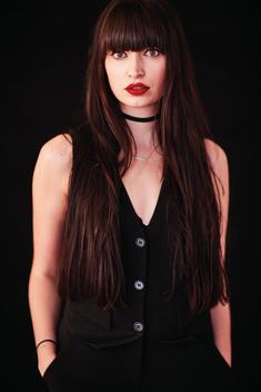 pale skinned brunette with red lipstick and bangs