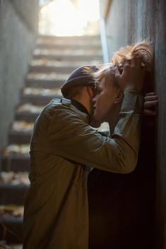 Two Teenagers Making Out In A Stairway