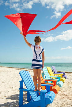 girl with red kite on a beach