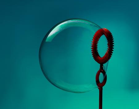 Still life of bubble and red bubble wand