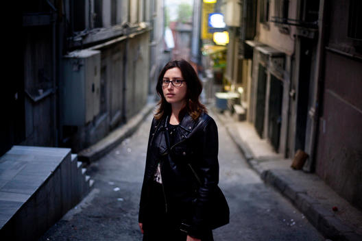 Young Turkish woman is standing between Karakoy\'s old streets in Istanbul.