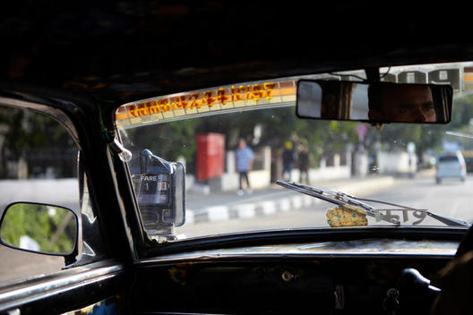 Taxi Interior With Hindu Decoration And Rear View Mirror, Mumbai, India.