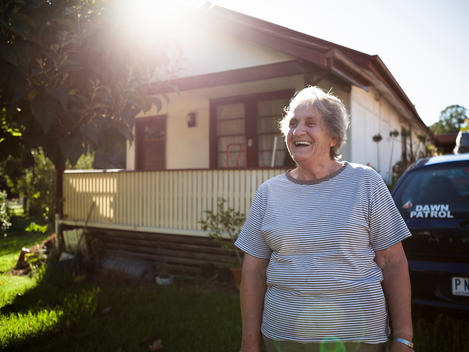 Dawn Thomas who is in her sixties and is the chief of her local rural fire brigade or Country Fire Authority laughs while she stands in front of her home.
