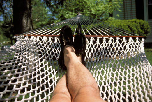 Feet and legs of photographer in hammock