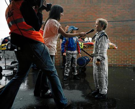 A Young Karting Driver Dressed In Race Suit Conducts A Post Race Interview, In The Rain, After Winning In The Final Of The Msa British Short Circuit Kartmasters Grand Prix, Pf International Circuit, Trent Valley Kart Club.