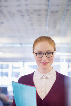 Businesswoman holding folder in office