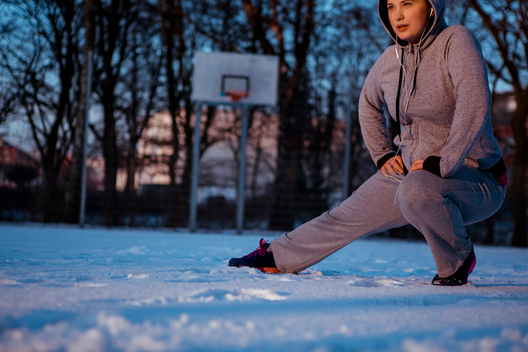 Woman stretching for outside winter workout