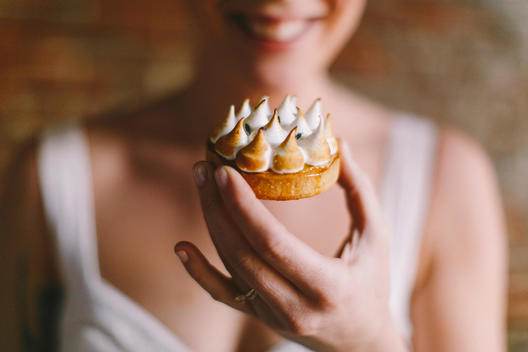 Close-up of Woman's Hands and Pastry Dessert