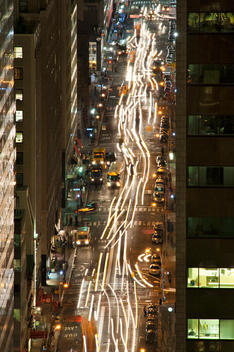 View From Above Of Busy Manhattan Street At Night With Streaming Lights And Traffic. New York, New York.