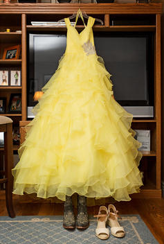 Yellow quinceanera dress hanging in living room