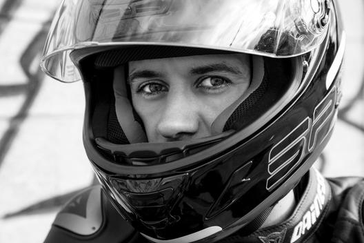 A motorcycle rider with a helmet visor up
