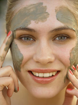 Beauty Image Of Model Putting Mud Face Mask On