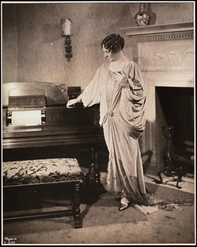 Mrs. Jones Standing Next To A Player Piano In What Is Probably A Room In The Aeolian Co. Office Building.