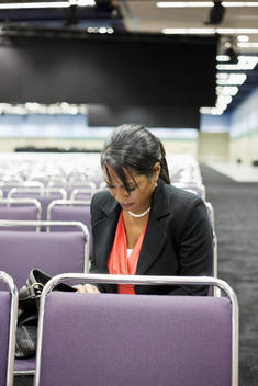 Black businesswoman waiting in empty conference center