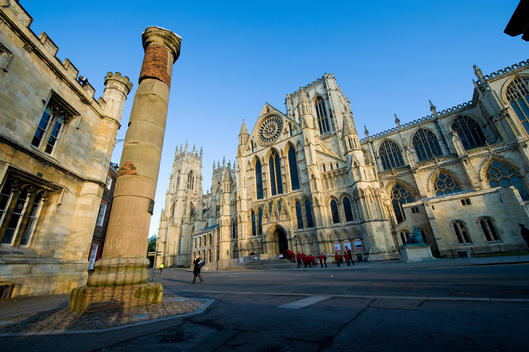York Cathedral exterior, blue skies, .York Minster is a cathedral in York, England and is one of the largest of its kind in Northern Europe. The minster has a very wide Decorated Gothic nave and chapter house, The nave contains the West Window, constructe
