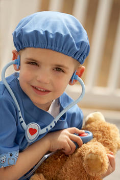Young Boy Playing Doctor With Stuffed Bear