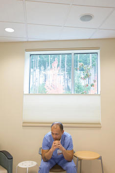 Pacific Islander nurse sitting in hospital room