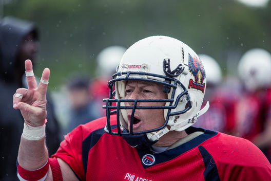 A women\'s football player signals from the sideline during a game.