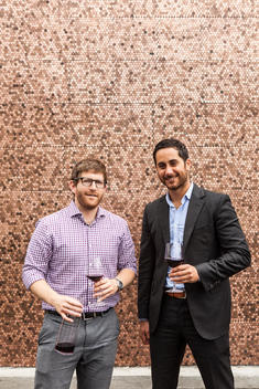 Eric Railsback and Brian McClintic in front of the penny-covered facade of Lucky Penny restaurant in the former Santa Barbara Fish Market building in Santa Barbara\'s Funk Zone. Their tasting room and wine shop, Les Marchands, is in the same complex.