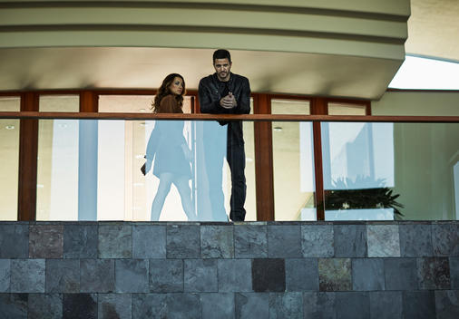 Male and female models posing on upper level patio.