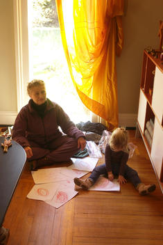 Grandmother draws with child on floor