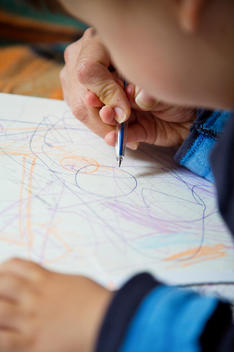 Close up of boy drawing with color pencil