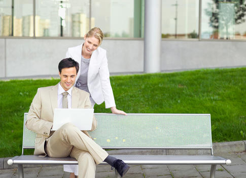 Germany, Baden-W?rttemberg, Stuttgart, Two businesspeople with laptop at park bench