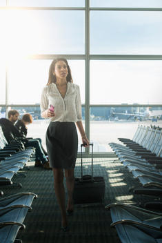 Mixed race businesswoman walking in airport